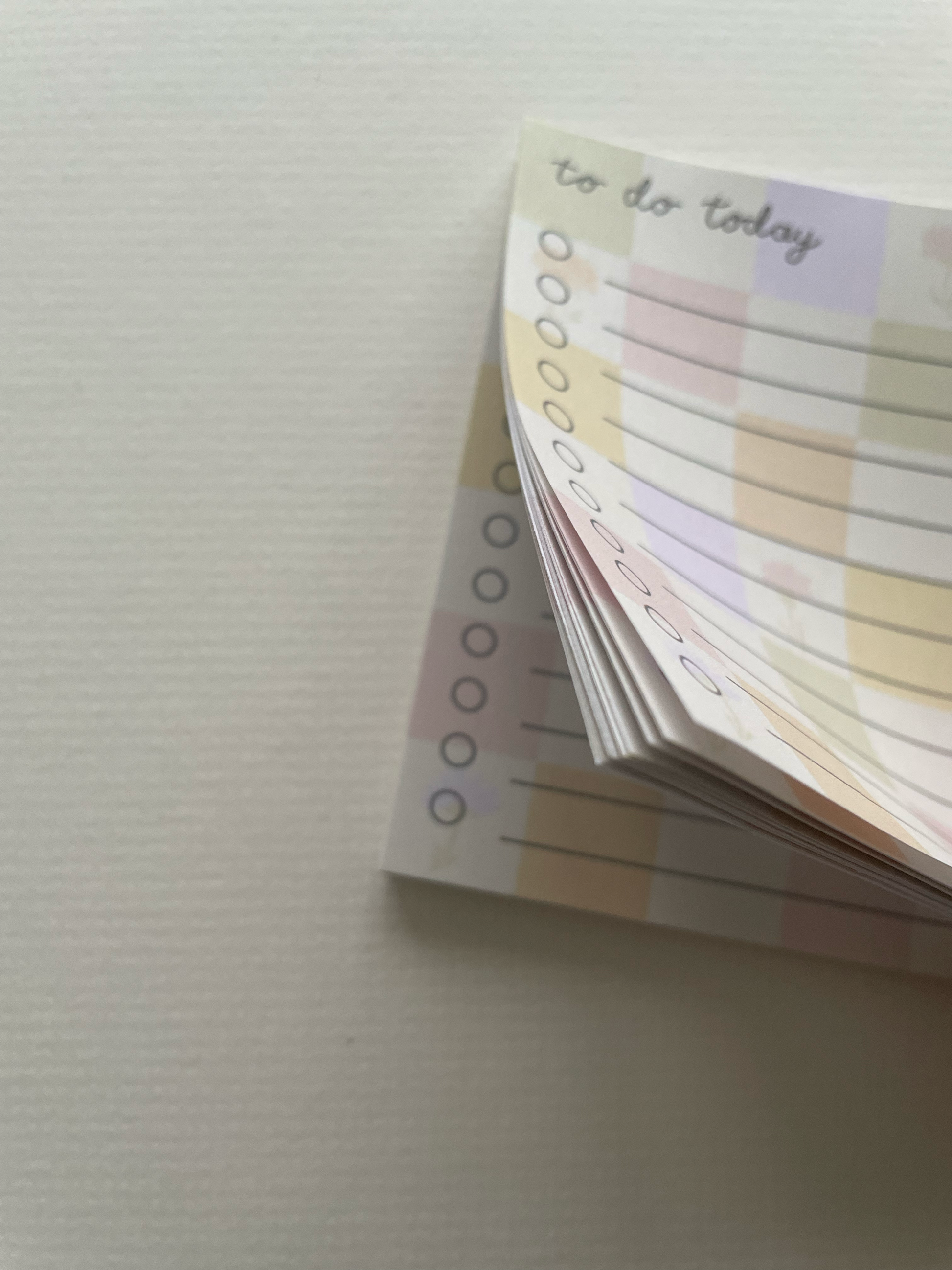 Stack of to-do list cards on a textured surface