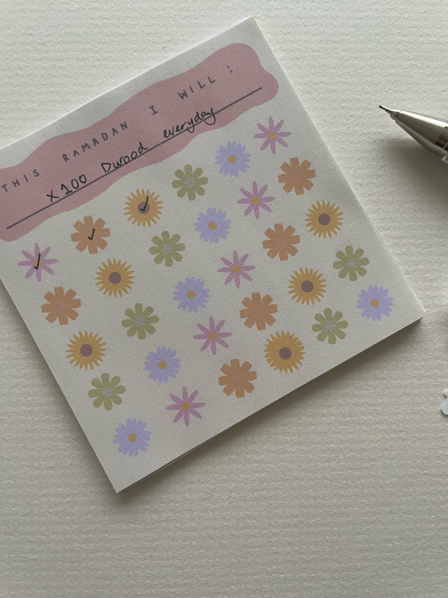 Notebook with floral stickers on a plain background